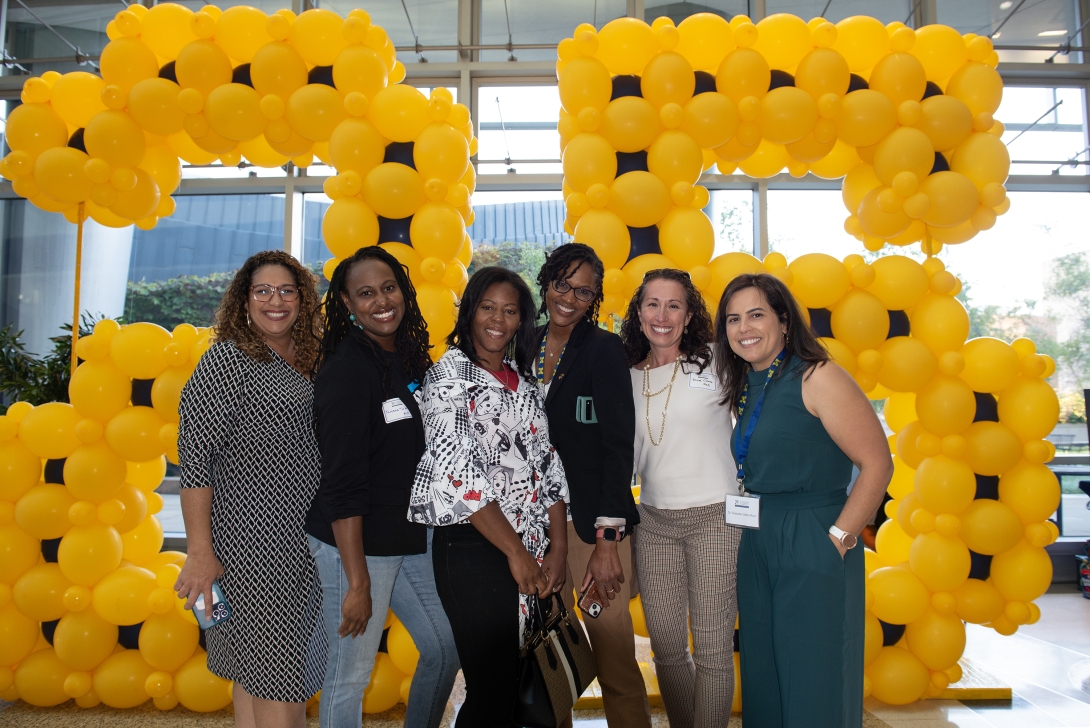 Group photo in front of a balloon backdrop