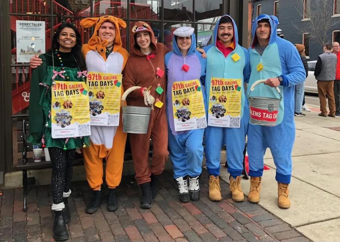 A group of medical students in onesies collecting funds for Tag Day