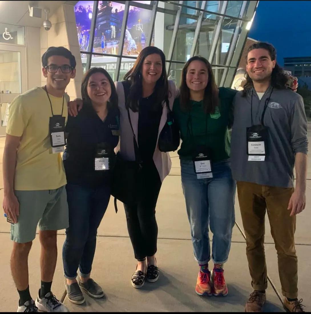 a group of five people outside at the National Science Olympiad