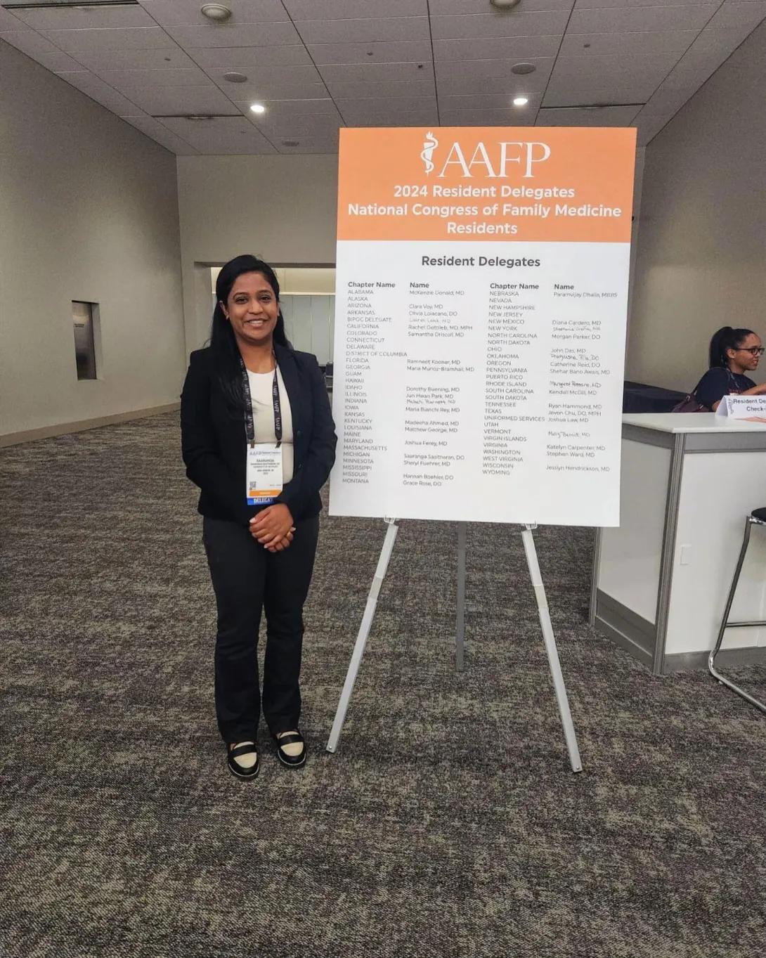 A person stands in front of the AAFP poster