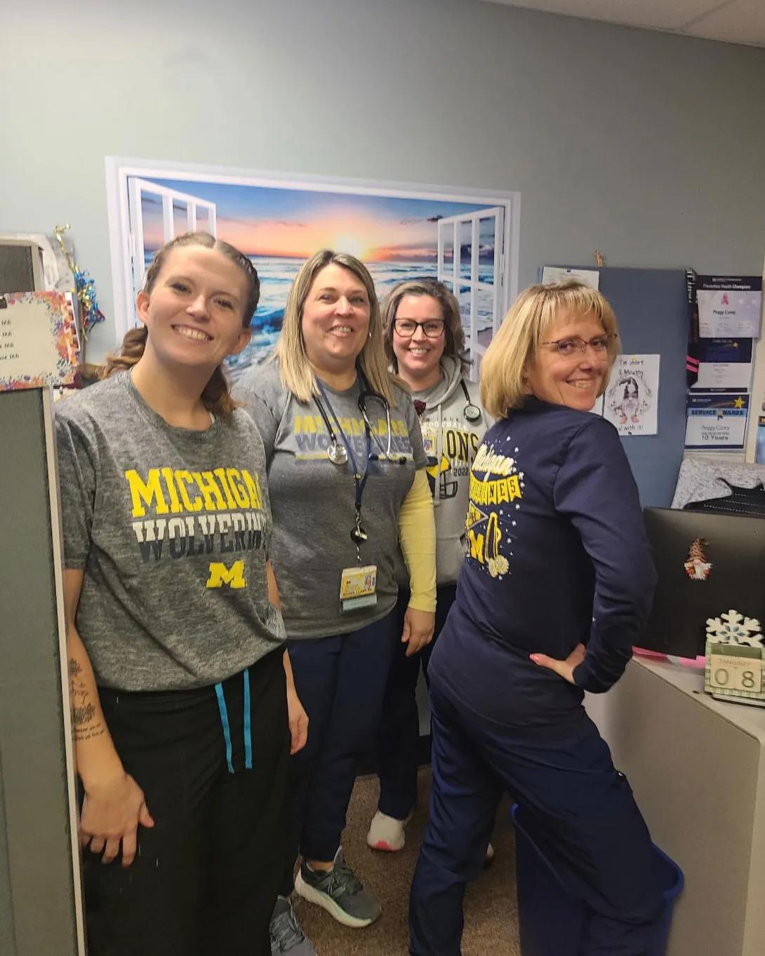 Four women appear to be having fun in office setting