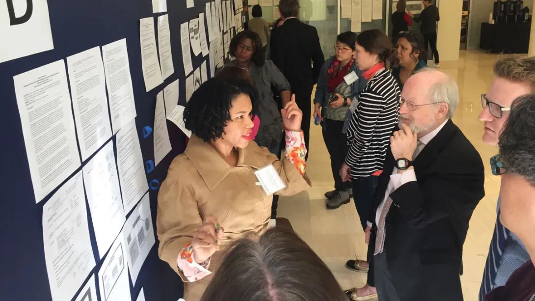 A women speaks at a mixed methods poster presentation