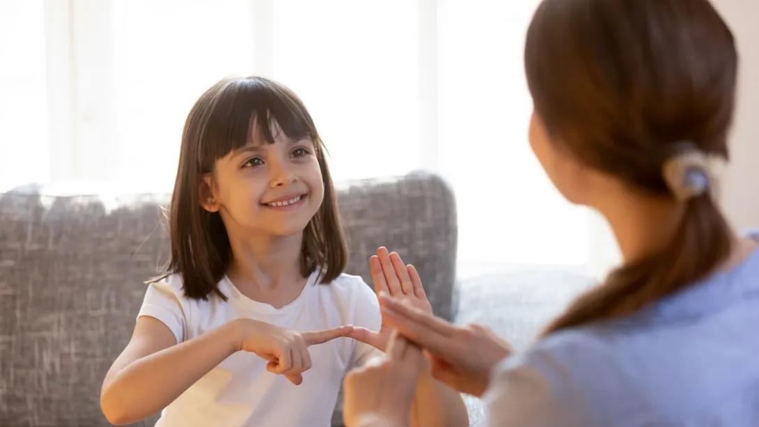 Little girl uses sigh language with her mom