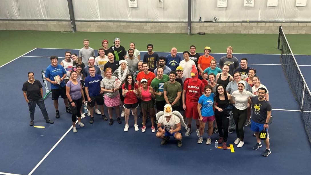Staff members at pickleball event on pickleball court