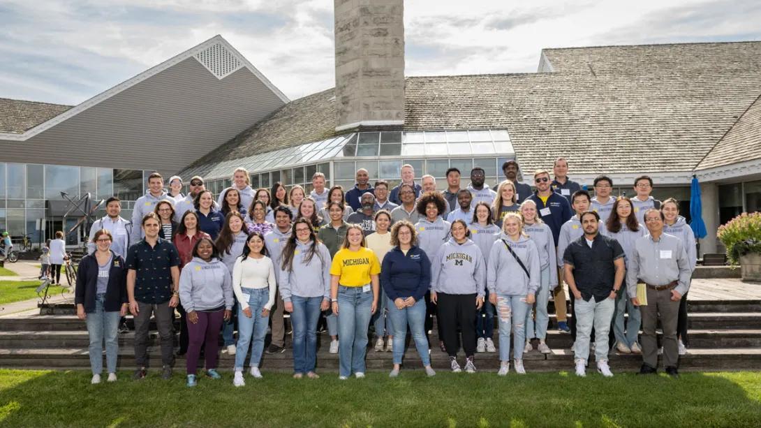 Researchers pose for group photo at outdoor retreat