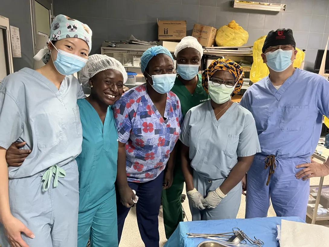 Six medical professionals wearing scrubs and surgical masks