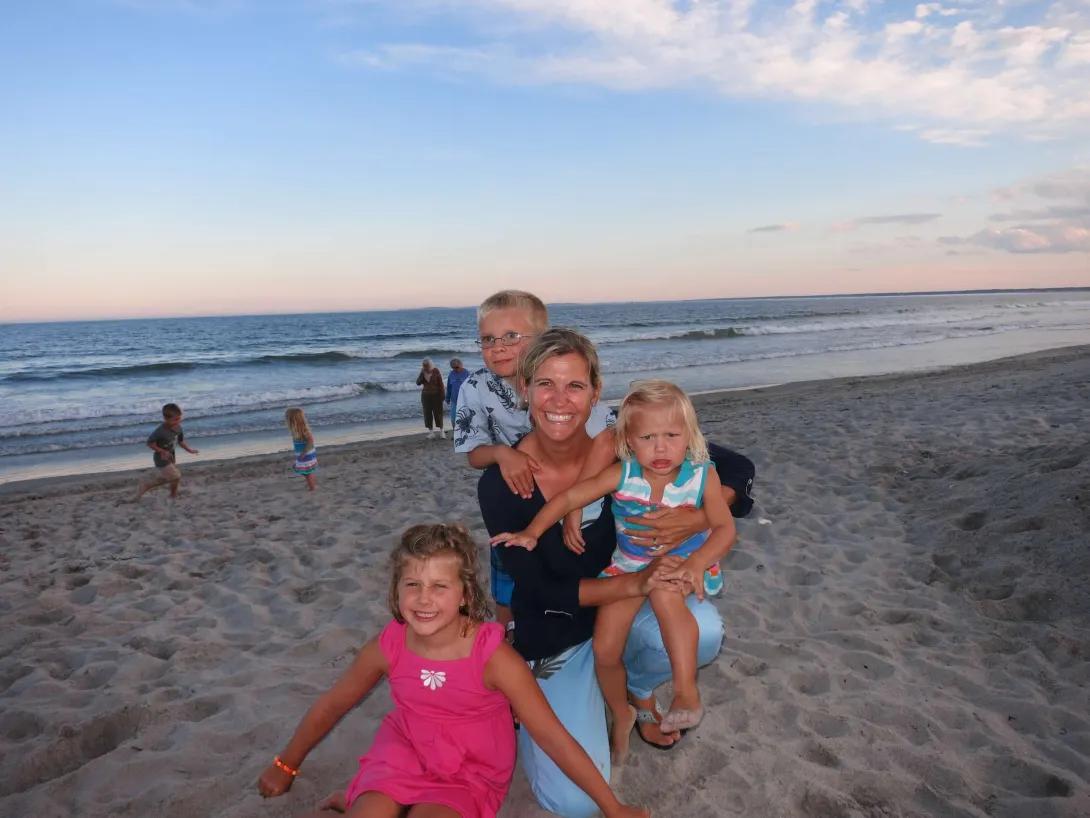 Courtney Reid with her three kids on the beach