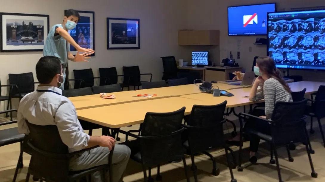 Pediatric Cardiology team members reviewing a presentation in a conference room