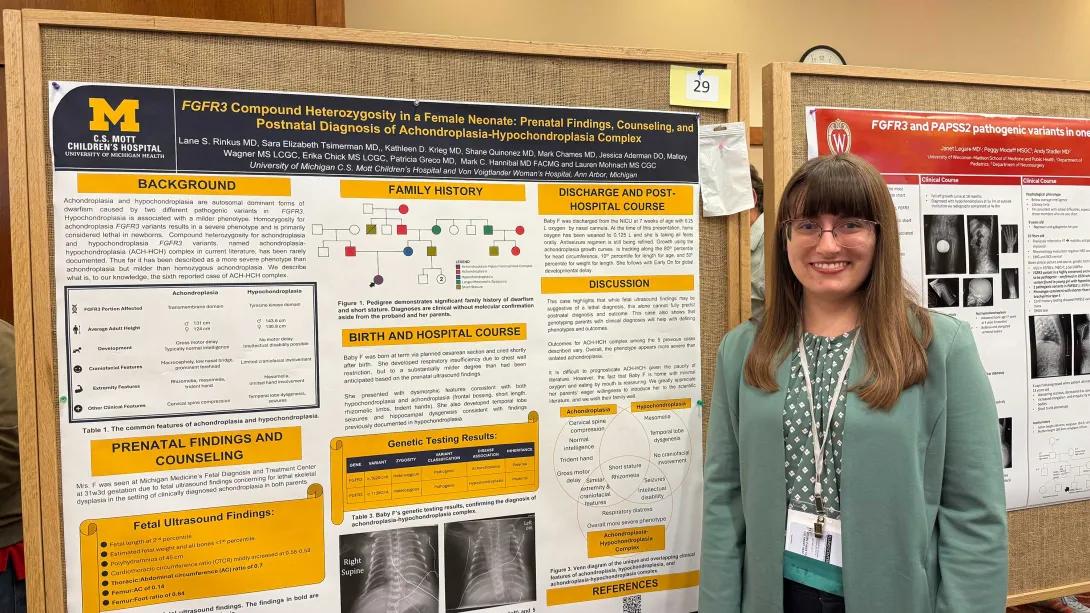 Pediatrics medical genetics team members standing by research poster