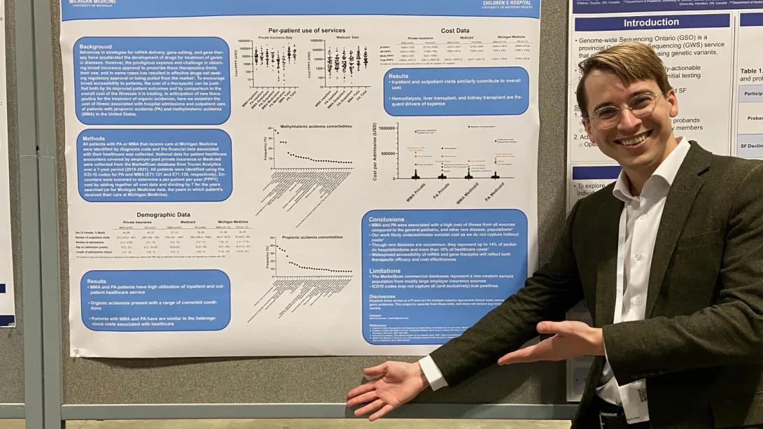 Pediatrics Medical Genetics trainee in front of research poster