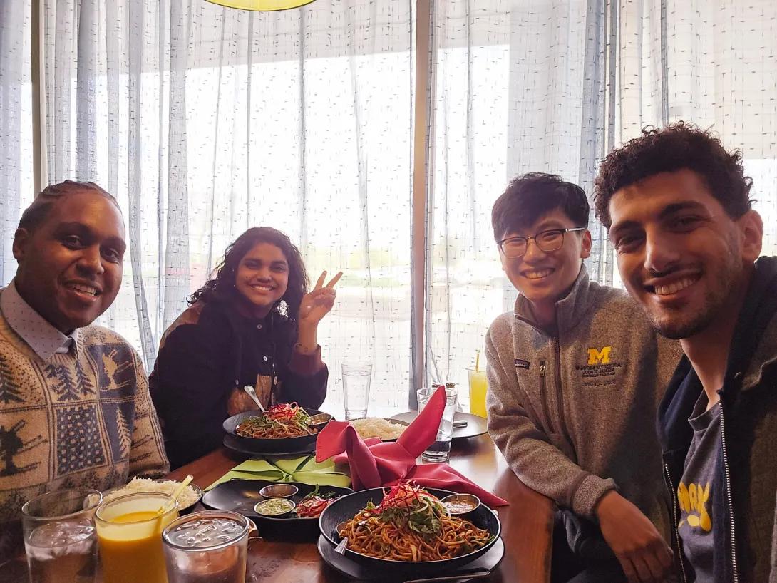 A group of four medical students enjoy a meal