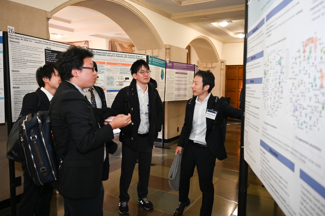 People look at posters during the poster session