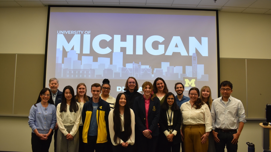 Group of students in front of a sign that says University of Michigan