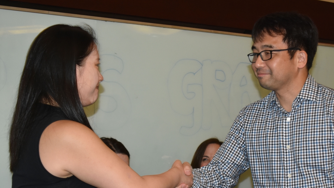 Handshake between faculty and student at graduation