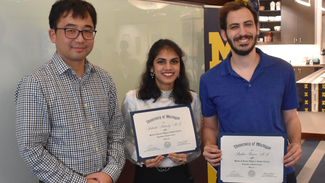 Group of students with diplomas