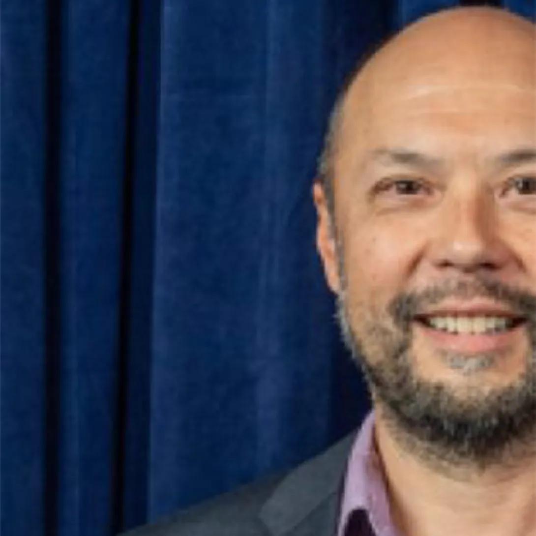 photo of a male professor with a dark blue background