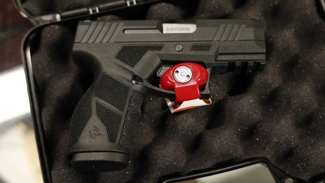 close up gun with safety lock in red