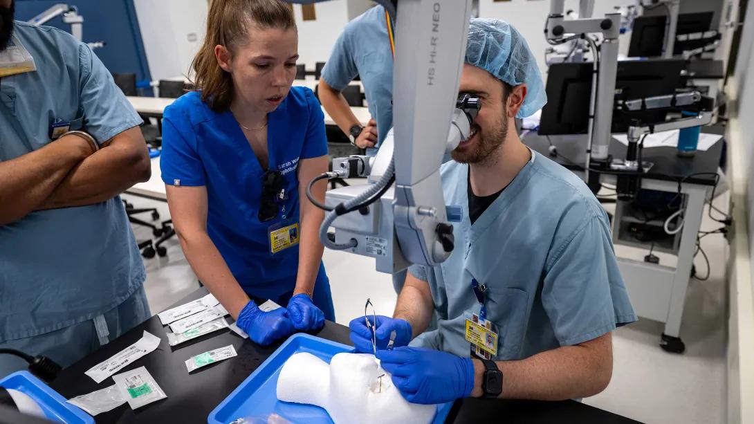 Ophthalmology residents practice microsurgery at microscopes in the Kellogg Eye Center wet lab.