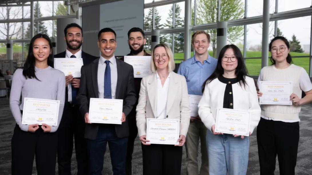 Research Retreat participants pose with “Best Poster” award certificates at the North Campus Research Complex.