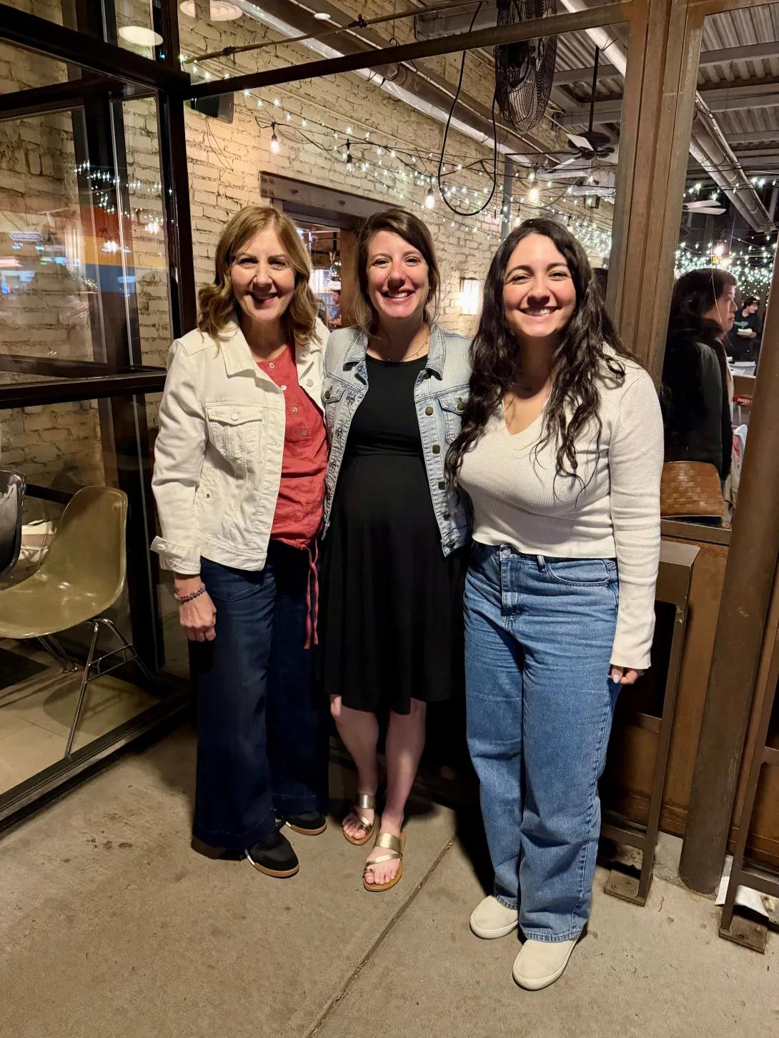 Marlene Woodard, Beckah Shaw, and a hospital medicine fellow standing outside a restaurant.