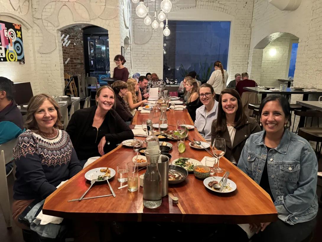 Hospital medicine faculty and fellows enjoying a meal together.