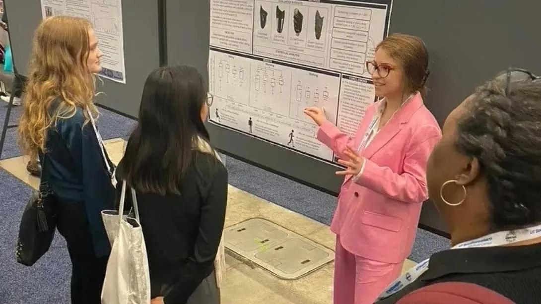 Team members standing around a research poster