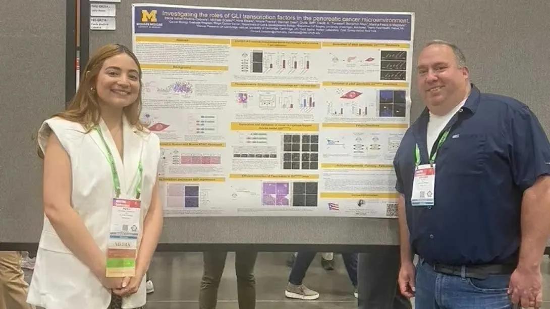Team members standing in front of a research poster