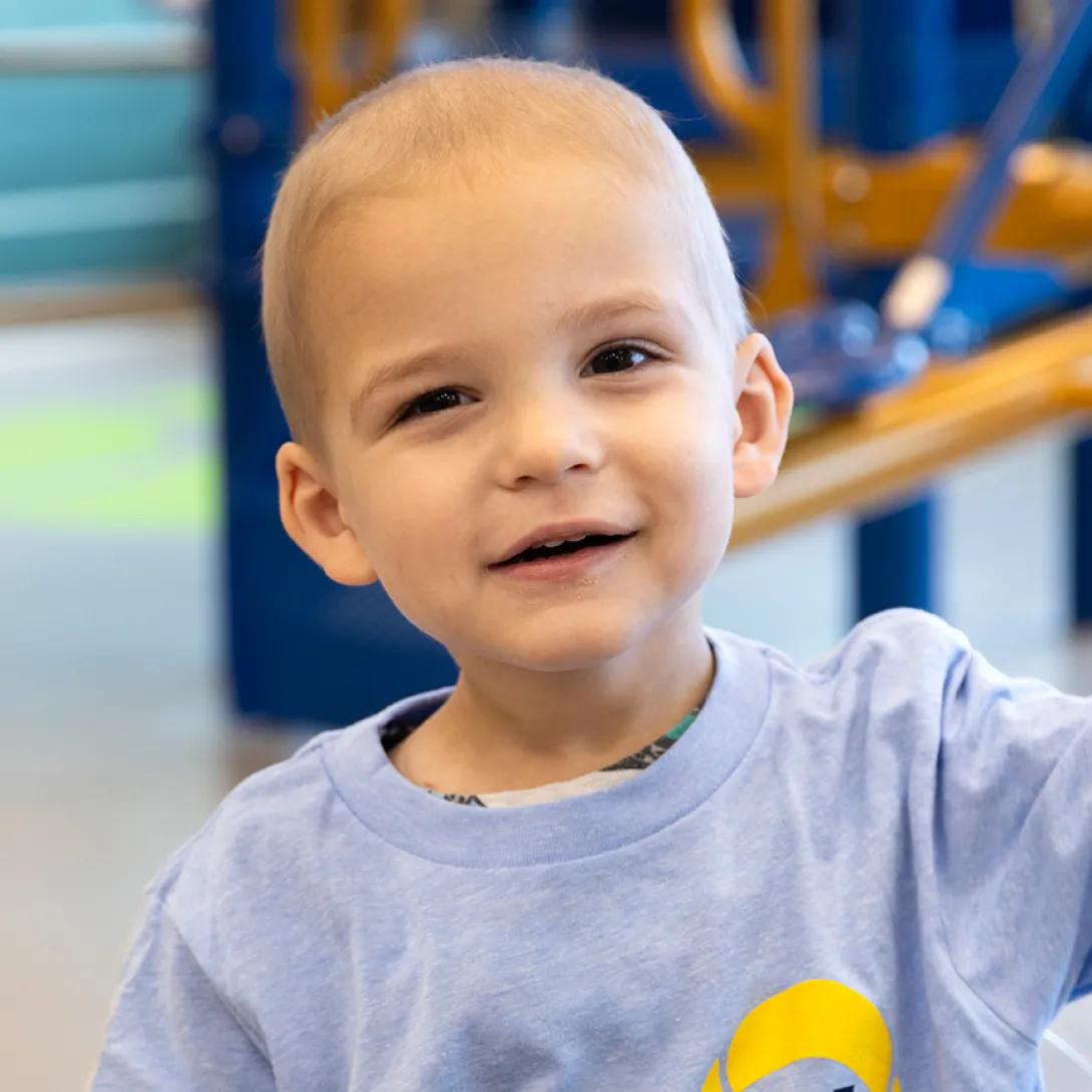 Headshot of a smiling child wearing a Block Out Cancer t-shirt.